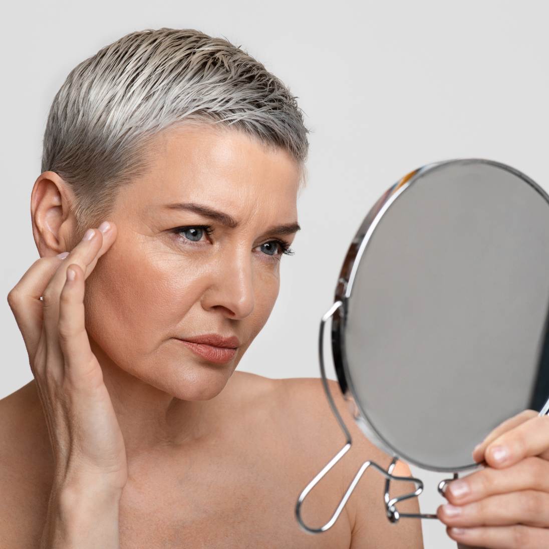 Woman looking into mirror